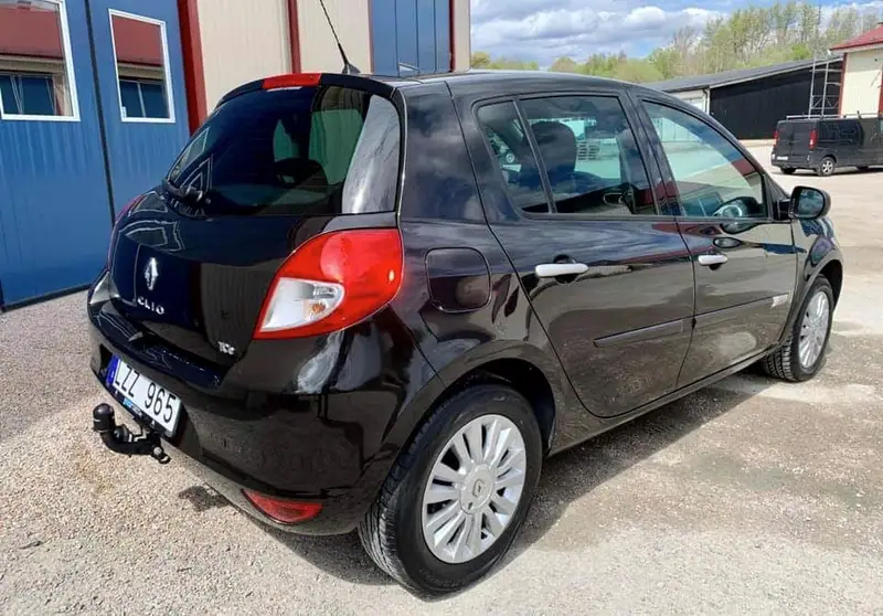 Svart Renault Clio snett bakifrån utanför verkstaden.
